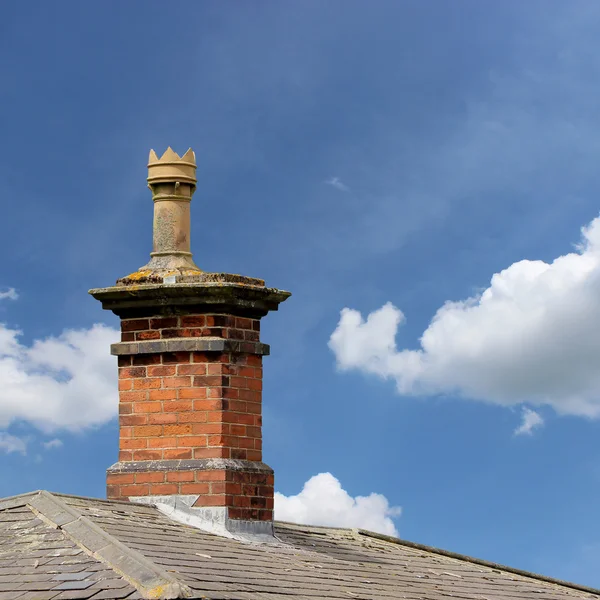 Chimney inspector working on a brick chimney, symbolizing safe inspections in Maryland